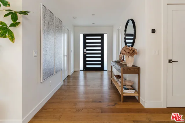 a view of room with furniture and wooden floor