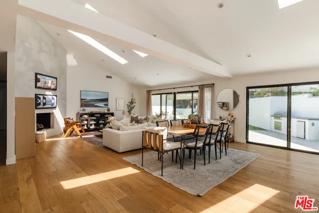 a view of a livingroom with furniture window and wooden floor