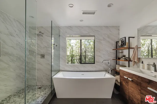 a bathroom with a bathtub and shower