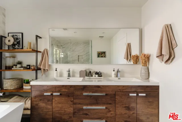 a bathroom with a sink vanity and a mirror