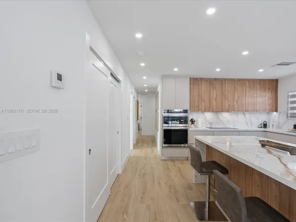 a kitchen with a sink and white cabinets