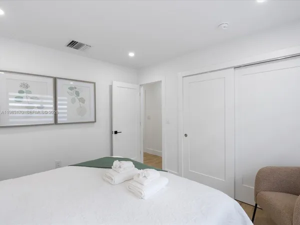 a bedroom with a bed and a couch