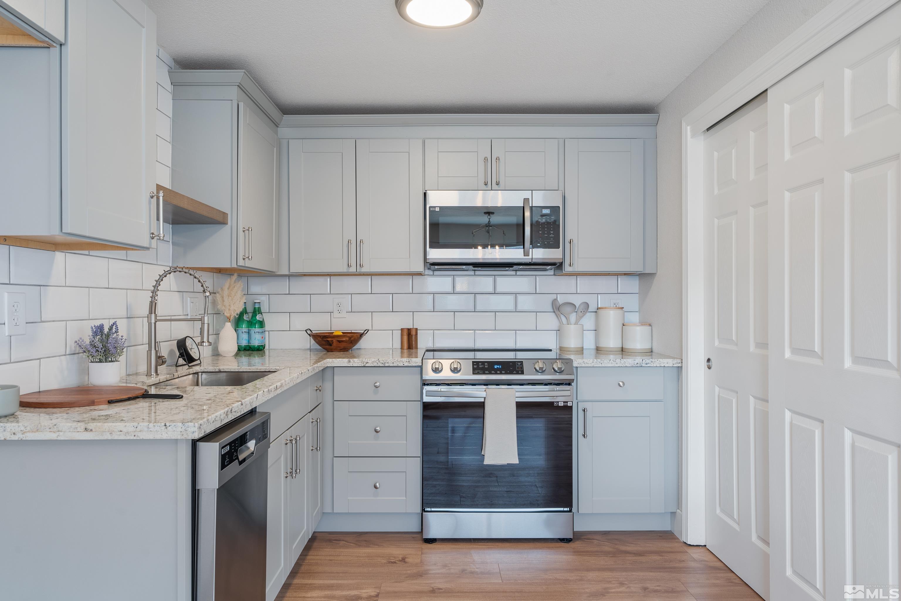 9495 Fremont Way Reno, NV 89506 - Photo 1 of 17 a kitchen with sink a microwave and cabinets