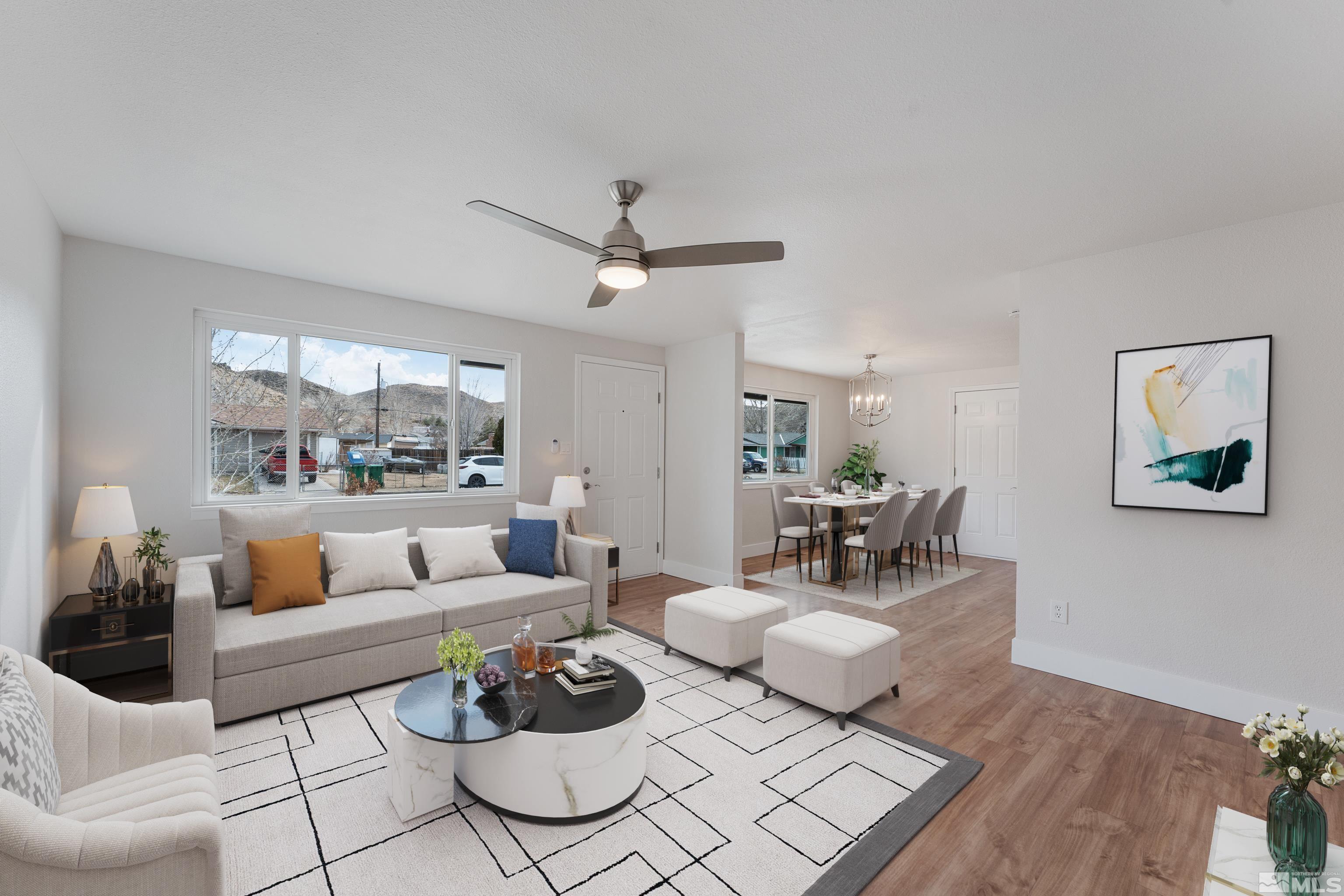 9495 Fremont Way Reno, NV 89506 - Photo 3 of 17 a living room with furniture a rug and a chandelier