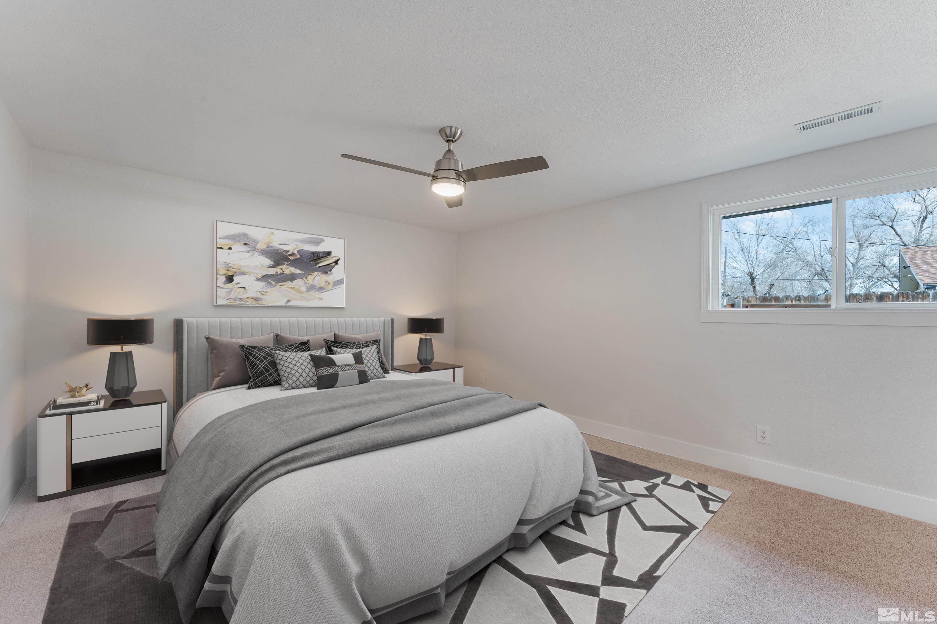 9495 Fremont Way Reno, NV 89506 - Photo 7 of 17 a bedroom with a bed and a chandelier