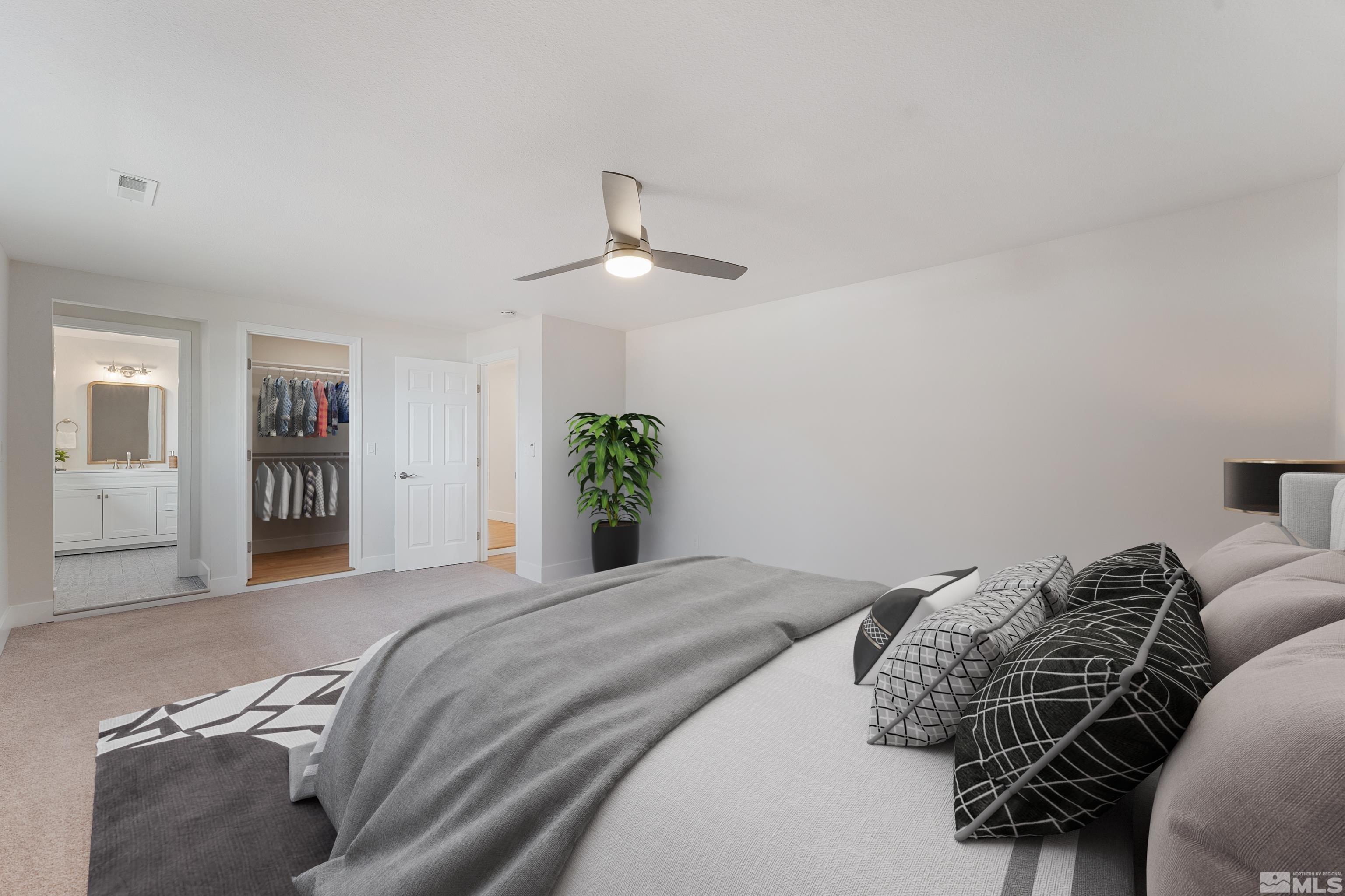 9495 Fremont Way Reno, NV 89506 - Photo 8 of 17 a bedroom with a large bed and a chandelier