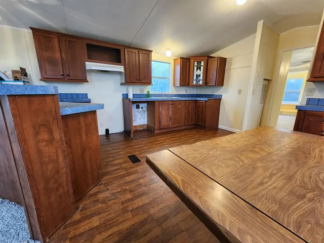 a kitchen with stainless steel appliances granite countertop a refrigerator sink and cabinets