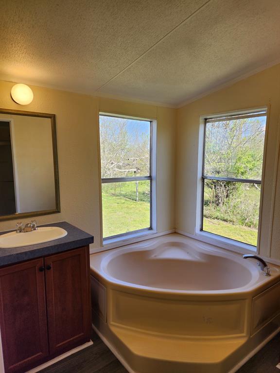 745 North Commerce Street Marquez, TX 77865 - Photo 4 of 11 a bed sitting in a bedroom next to a window