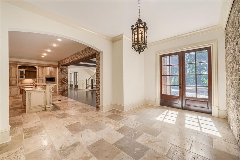 7965 Robin Road Cumming, GA 30041 - Photo 20 of 64 a view of a hallway with wooden floor and a chandelier