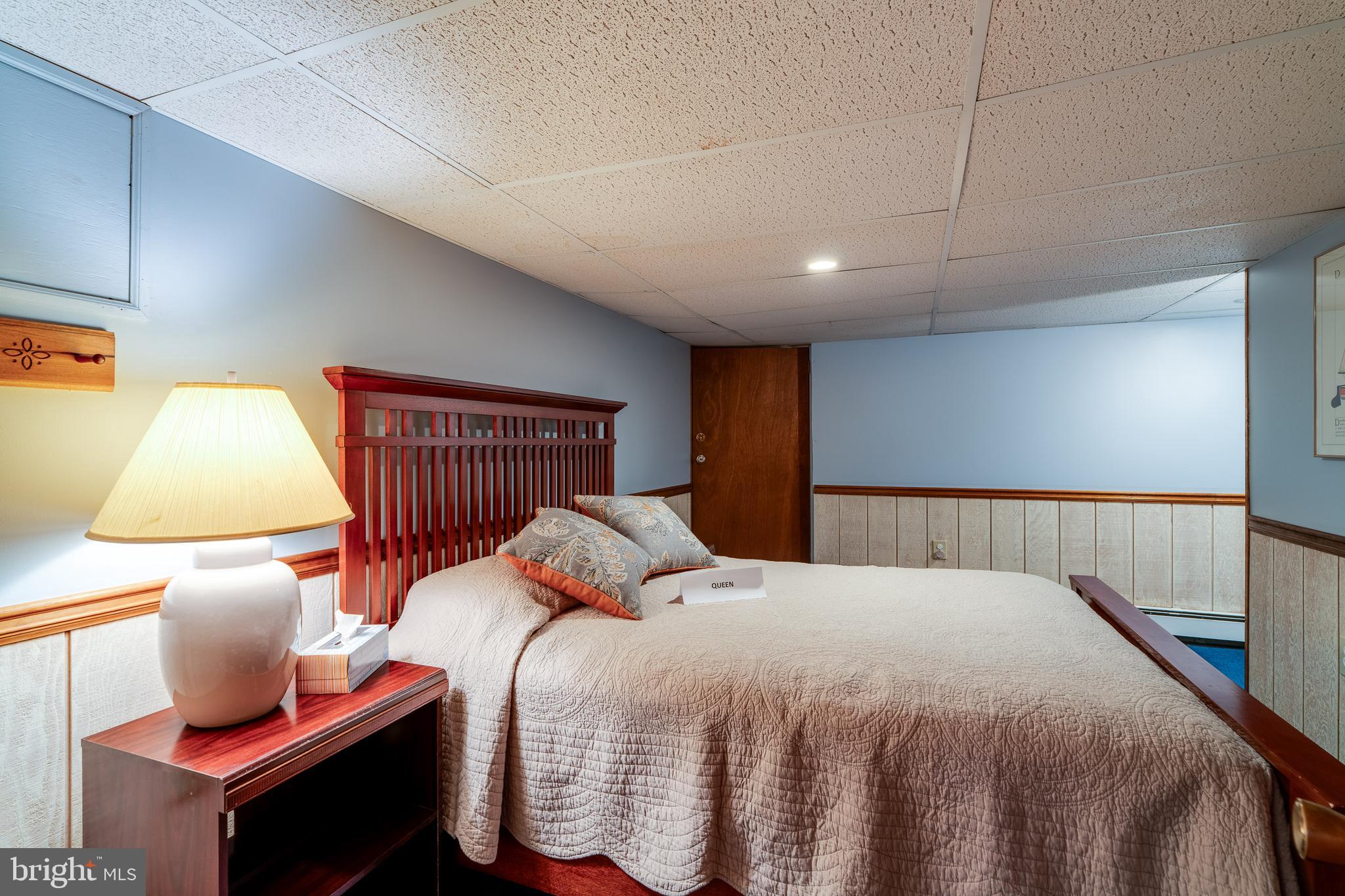 510 Bluebird Road Lititz, PA 17543 - Photo 21 of 32 a bedroom with a bed and lamp