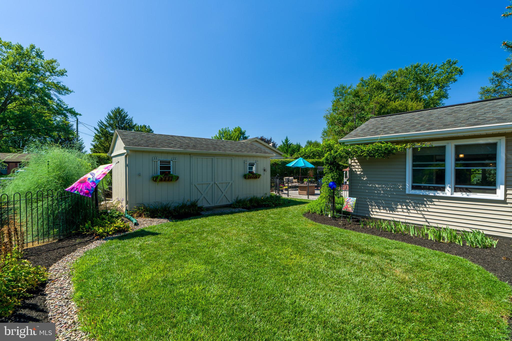 510 Bluebird Road Lititz, PA 17543 - Photo 30 of 32 a view of a house with a back yard and a garden