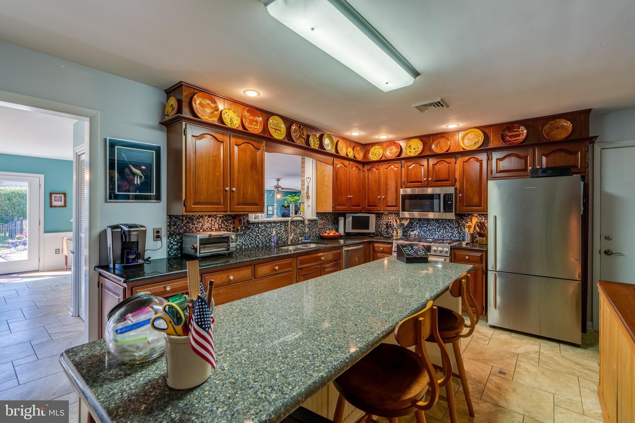 510 Bluebird Road Lititz, PA 17543 - Photo 6 of 32 a kitchen with stainless steel appliances granite countertop a refrigerator a stove and white cabinets