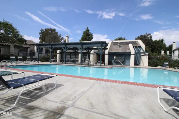a view of house with swimming pool outdoor seating
