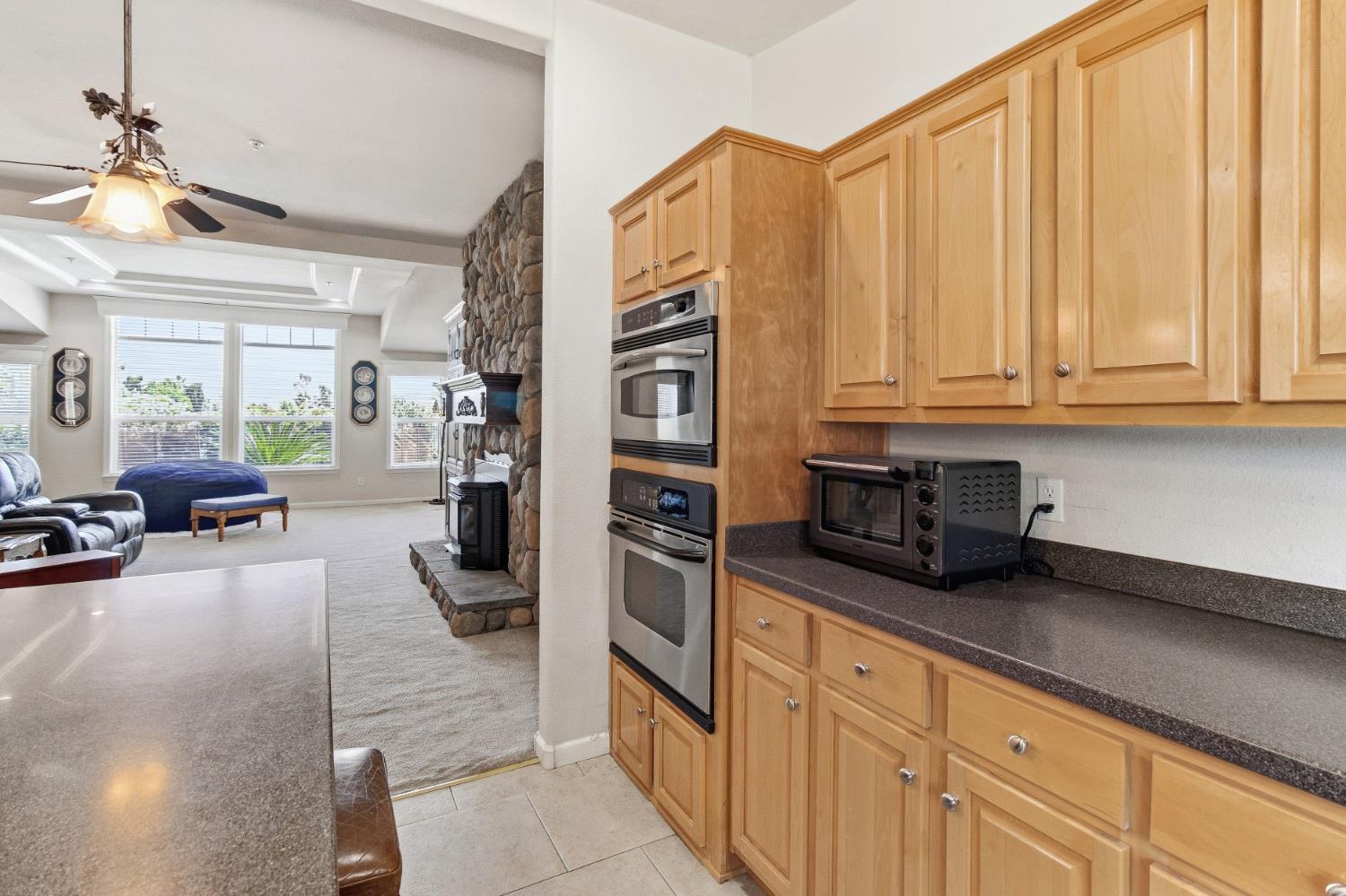 12390 Hobday Road Wilton, CA 95693 - Photo 22 of 92 a kitchen with stainless steel appliances granite countertop a refrigerator and a stove top oven
