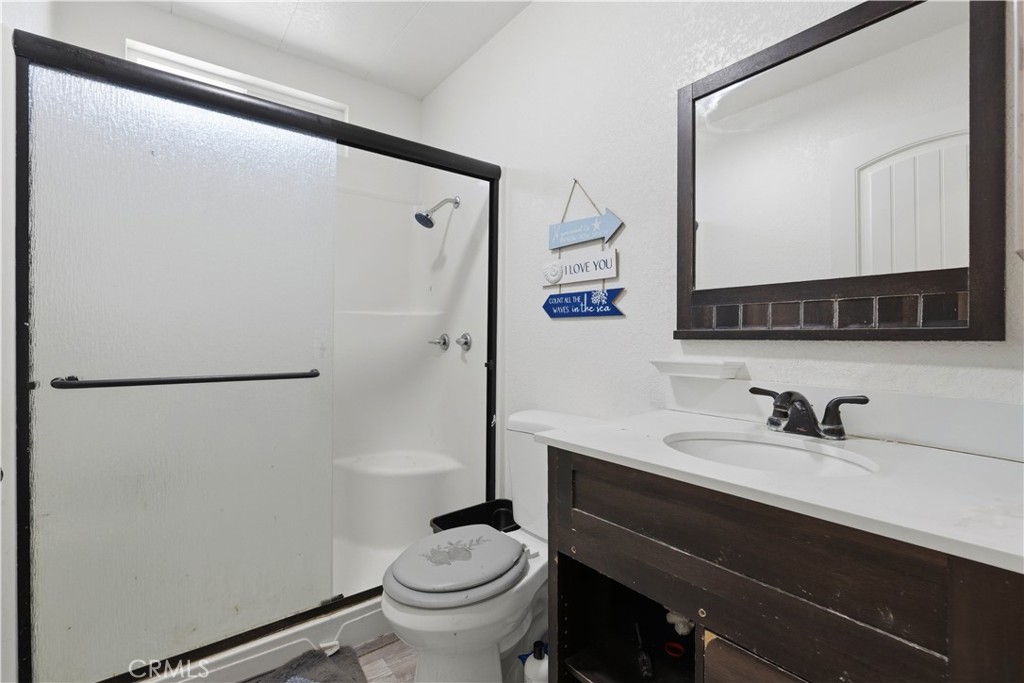 5885 Dos Palmas Road Phelan, CA 92371 - Photo 19 of 40 a bathroom with a sink and a mirror
