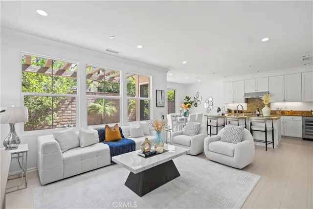 a living room with furniture and view of kitchen