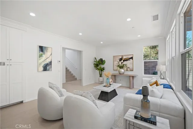 a kitchen with stainless steel appliances a stove a sink refrigerator and white cabinets