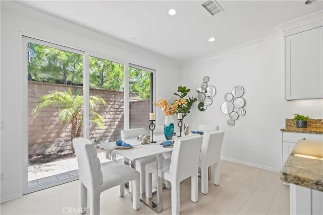 a living room with stainless steel appliances kitchen island granite countertop furniture a rug kitchen view and a table