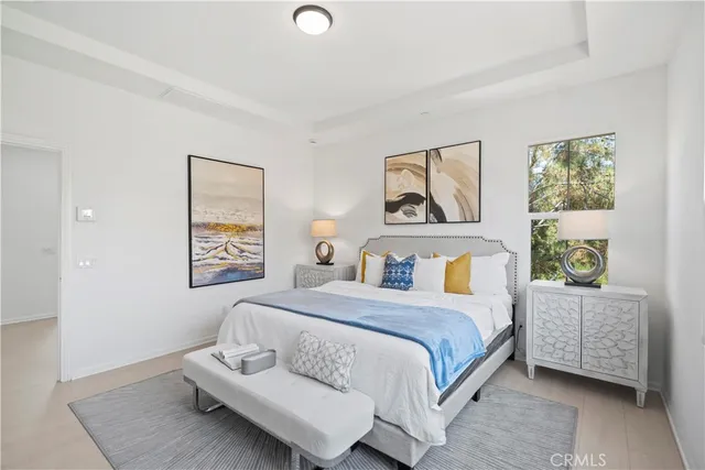 a bedroom with a bed and a large window