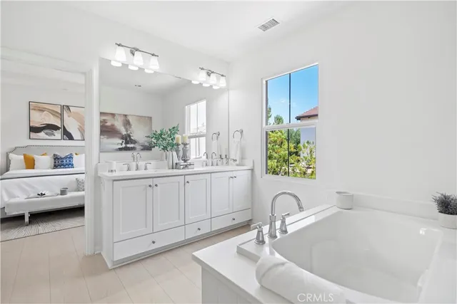 a bathroom with a double vanity sink mirror and shower