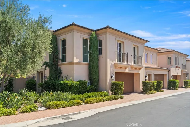 a front view of a house with plants and trees