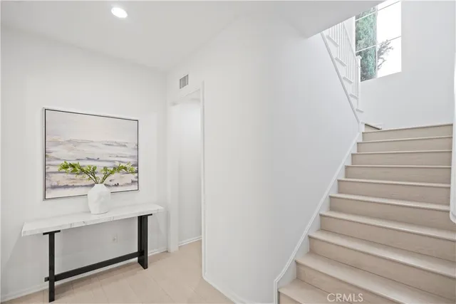 a living room with furniture and large windows
