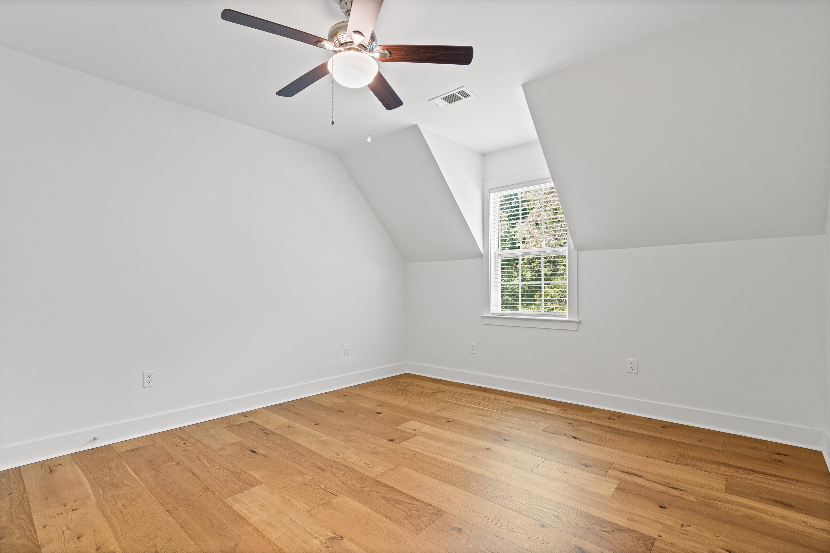 620 Diffee Road Moscow, TN 38057 - Photo 17 of 25 White walls, wood flooring, and a ceiling fan, and a walk in closet