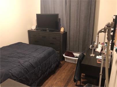 1734 West 35th Street, Unit 1R Chicago, IL 60609 - Photo 7 of 7 a bedroom with a bed and a chair