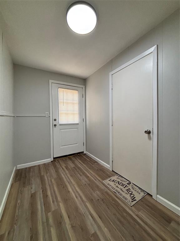 903 1st Street Bridgeport, TX 76426 - Photo 12 of 17 an empty room with wooden floor and windows
