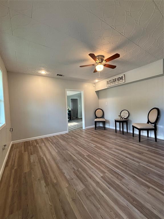 903 1st Street Bridgeport, TX 76426 - Photo 2 of 17 a view of a livingroom with a hardwood floor and a ceiling fan
