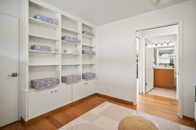 a view of bedroom with wooden floor and cabinet