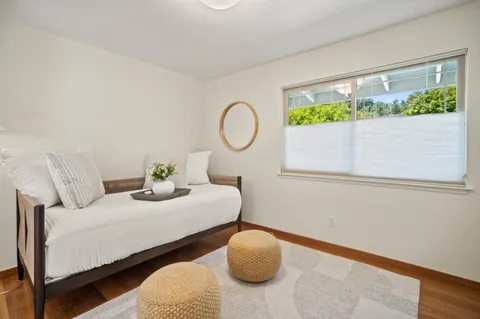 a bedroom with bed and a chair