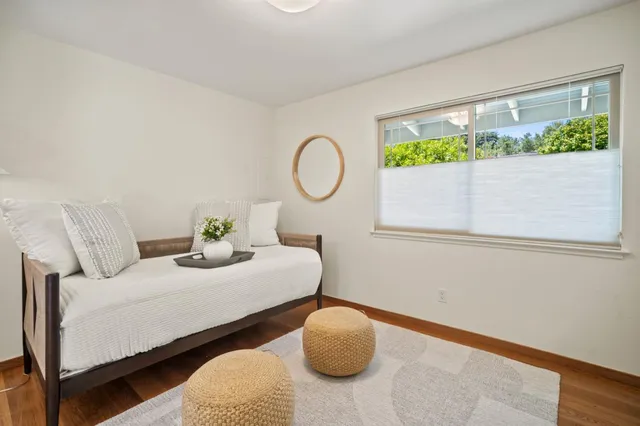 a bedroom with bed and a chair