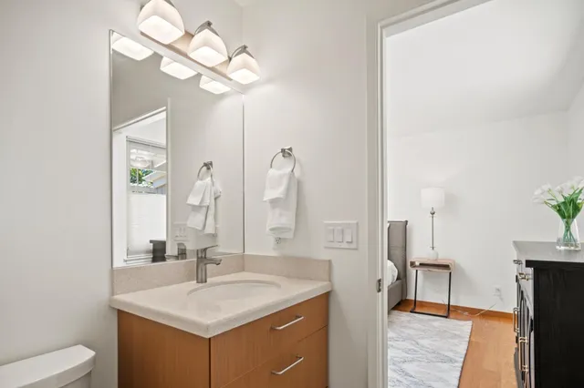 a bathroom with a sink a light fixture and a mirror