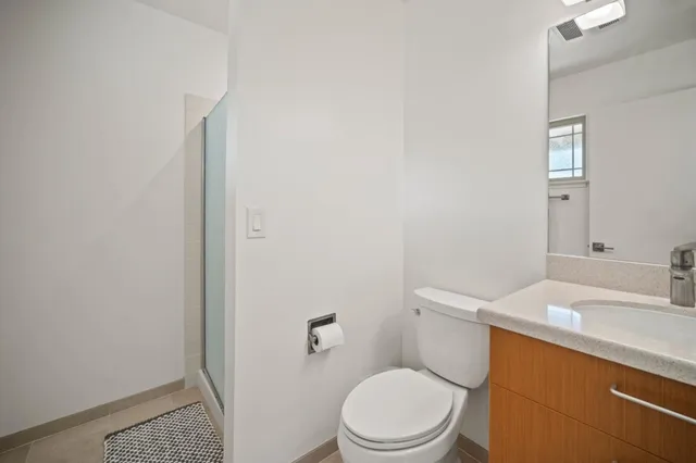 a white toilet sitting next to a bathroom sink