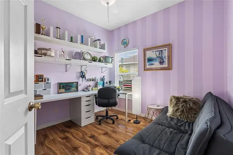a livingroom with workspace and a couch