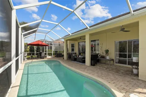 a view of a patio with table and chairs under an umbrella