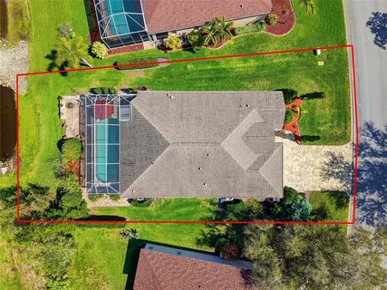 an aerial view of a house with a garden and yard