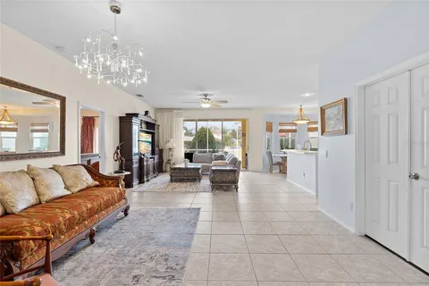 a living room with furniture and a chandelier