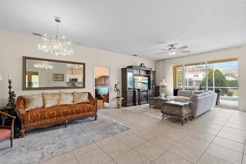 a living room with furniture and a chandelier