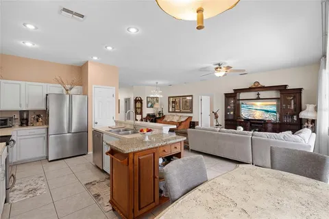 a kitchen with a stove a refrigerator and a microwave