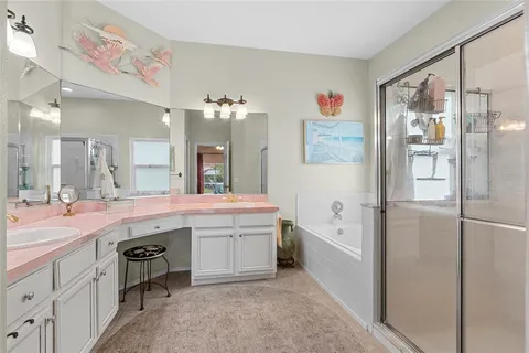 a spacious bathroom with a granite countertop sink a large mirror a shower and bathtub