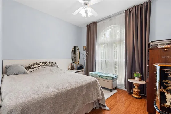 a bedroom with a bed and a chandelier