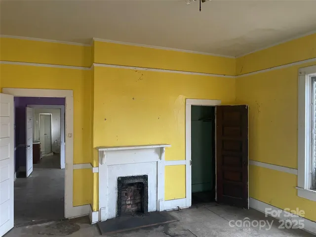 a view of a room with window chandelier and front door