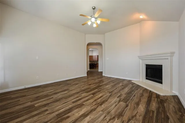 a view of a livingroom with a chandelier fan and a fireplace