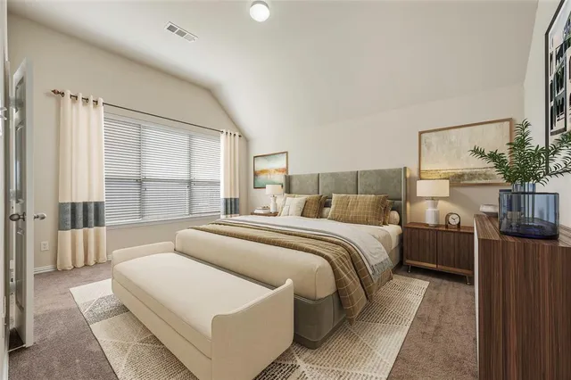 a bedroom with a large bed and a large window