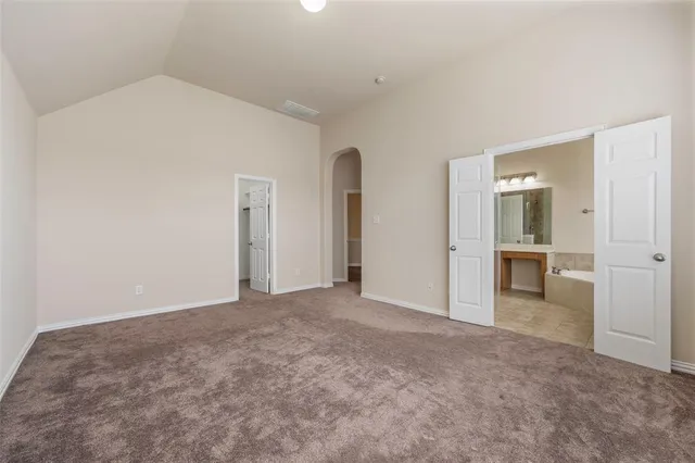 a spacious bathroom with a tub shower and sink