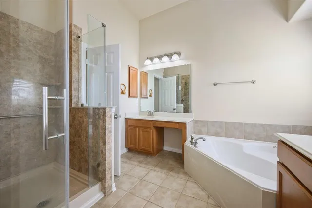 a bathroom with a bathtub a sink and a large mirror