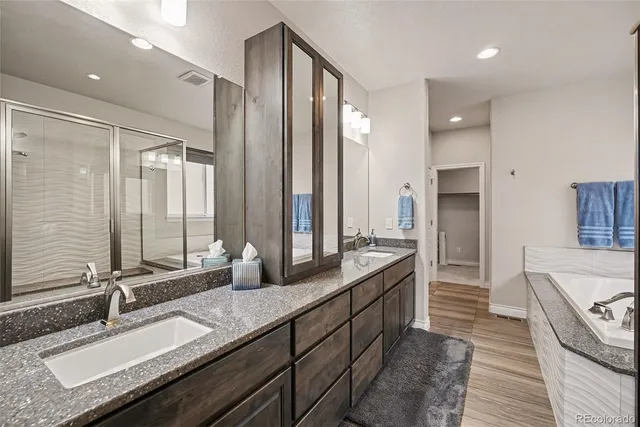 a bathroom with double vanity sinks double vanity shower and a bathtub