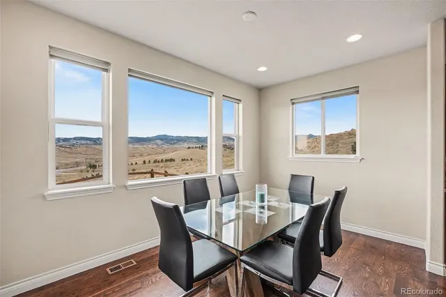 a dining room with furniture and window